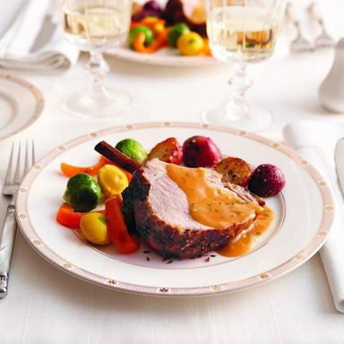 Cumin-crusted pork loin roast with brandied orange sauce