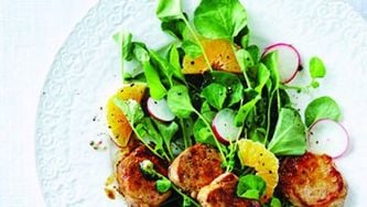Pan-seared pork medallions on watercress