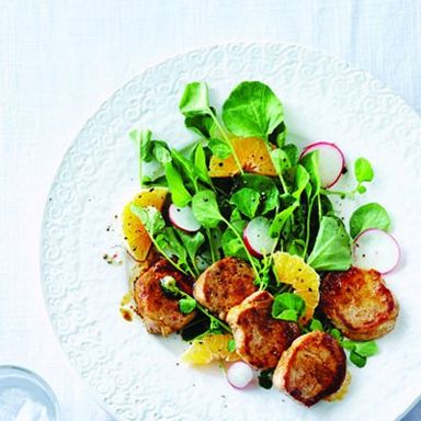 Pan-seared pork medallions on watercress