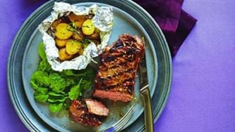 Grilled steak and foil-wrapped potatoes