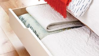 Stash seasonal bedding in hidden storage