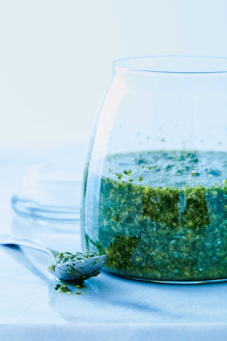 a jar of classic basil pesto made with garlic; basil leaves; toasted pine nuts; parmesan; lemon juice; salt; olive oil and vegetable oil for a post on a classic basil pesto recipe