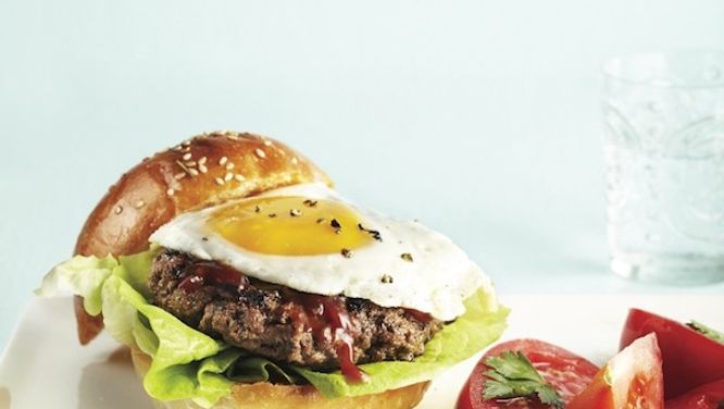 Steak and egg burger with summer tomato salad