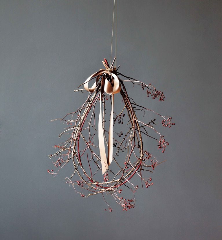a loop of red dogwood shaped into a wreath for a piece on how to make foraged wreaths