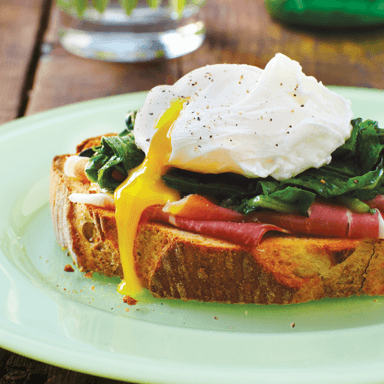 Poached eggs over sautéed greens and toast