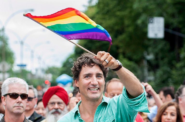 Prime Minister Justin Trudeau waves the rainbow flag as he attends the annual pride parade in Montreal, Sunday, August 14, 2016. THE CANADIAN PRESS/Graham Hughes