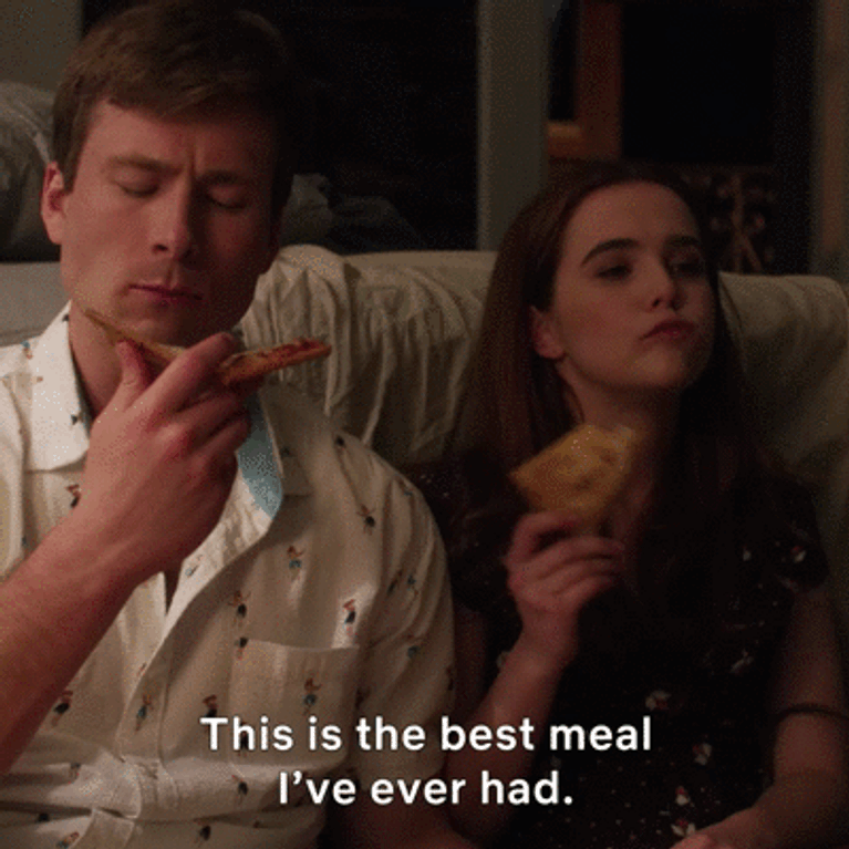 Gif from Set It Up of them eating pizza 