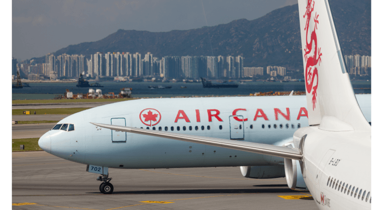 what does the aeroplan deal mean for your points: Air Canada plane at airport with ocean view skyline in back