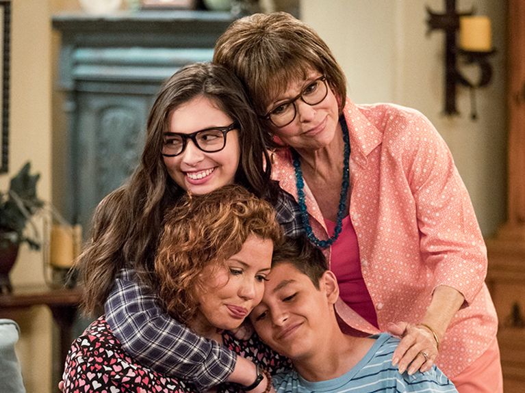 Family of four hugs each other in best netflix sitcom, one day at a time