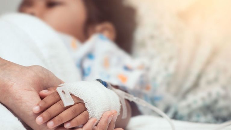 acute flaccid myelitis-a child lies in a hospital bed