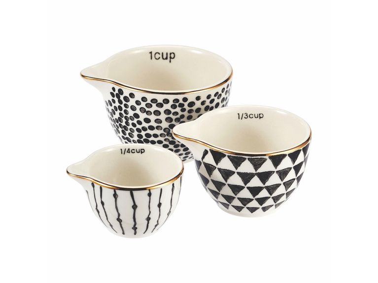 Holiday Gift Guide 2018 three black and white ceramic measuring cups with gold rim