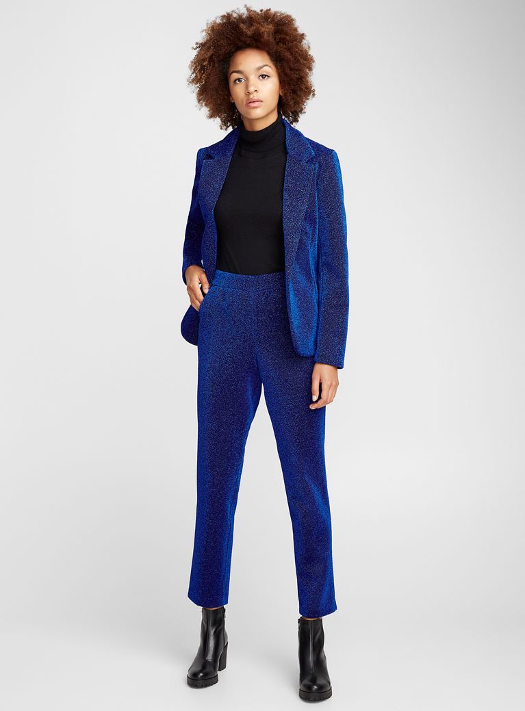christmas party outfits: woman in sparkly blue pantsuit set