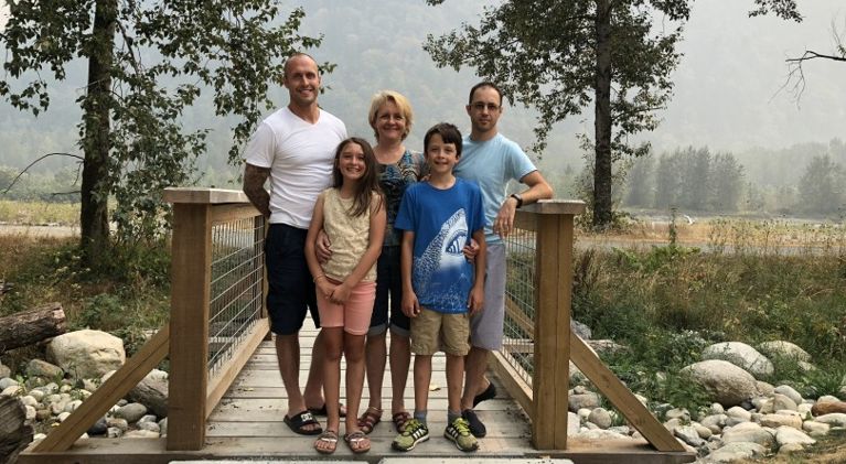 opioid addiction stigma-a family of four sit on a couch with New Years Eve decorations