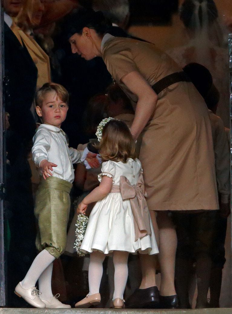 Prince George and Princess Charlotte hold their nannies hand as they walk into church