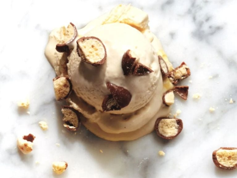 A scoop of malted milk ice cream on a marble countertop