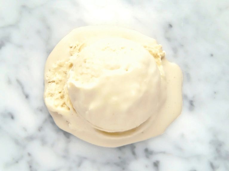 a scoop of london fog ice cream on a marble countertop