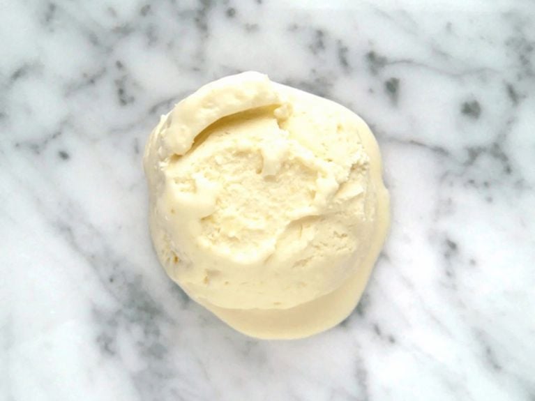 a scoop of miso ice cream on a marble countertop