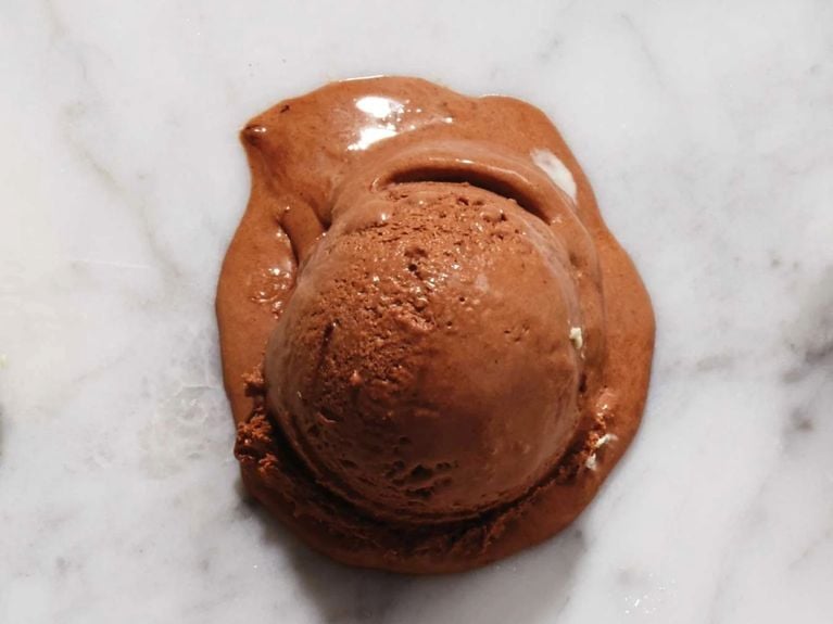 A scoop of no-churn chocolate ice cream on a marble surface; the ice cream is made without a machine, with 1 cup 35% cream 1/4 cup unsweetened cocoa powder, such as Fry's; 1/2 300-mL can sweetened condensed milk for a post on an easy no-churn chocolate ice cream recipe