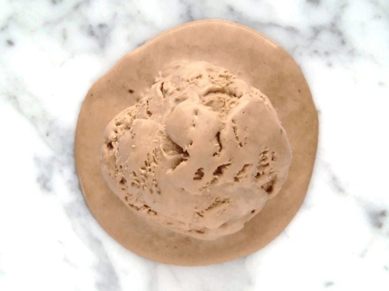 a scoop of nutella ice cream on a marble countertop