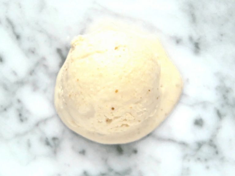 a scoop of peanut butter ice cream on a marble countertop