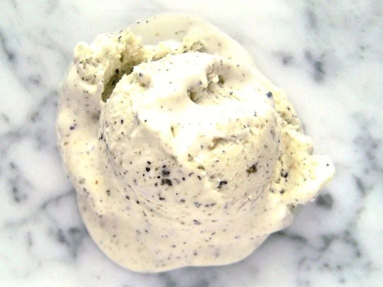 a scoop of sesame ice cream on a marble countertop