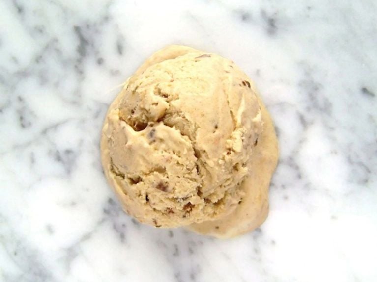 a scoop of sticky toffee ice cream on a marble countertop