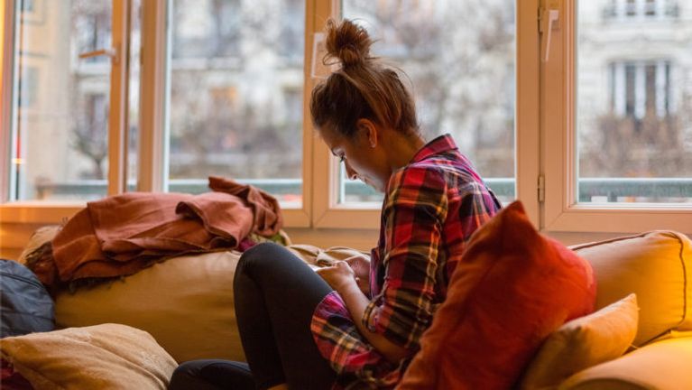 An anxious woman looking at her phone