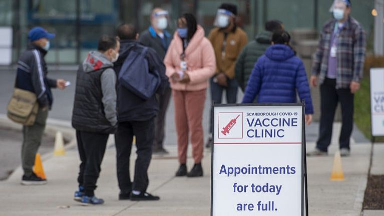 Visitors arrive at a pop up COVID-19 vaccine clinic at David and Mary Thomson high school in Toronto on Thursday, April 29, 2021. Hundreds of people lined up through the night in the hard hit community. THE CANADIAN PRESS/Frank Gunn