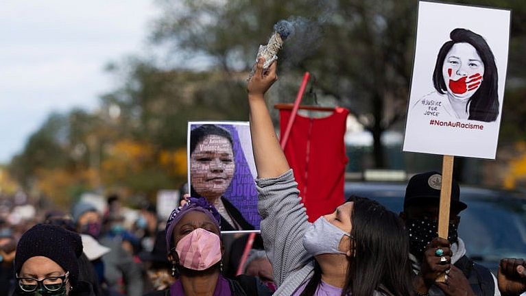 A woman smudges during a march to demand justice and raise awareness for Echaquan (Christinne Muschi/Reuters)