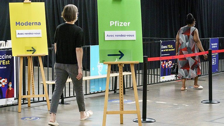 A woman arrives at a COVID-19 vaccination clinic in Montreal, on Monday, June 21, 2021. THE CANADIAN PRESS/Paul Chiasson