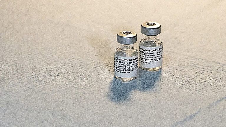 Two vials of the Pfizer-BioNTech vaccine sit on a table at a COVID-19 vaccination clinic in Halifax on May 24, 2021. (Andrew Vaughan/CP)