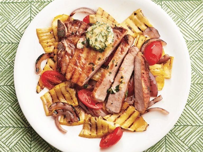 Grilled pork chops with basil butter and grilled vegetables