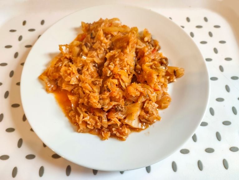 A white bowl filled with cabbage roll stir-fry.