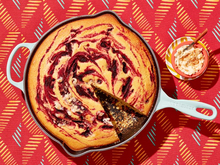 Skillet cornbread with a roasted beet swirl served alongside a toasted coconut rhum butter