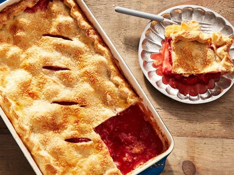 Strawberry sheet pan pie with a serving on a plate