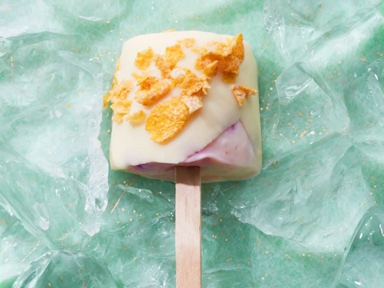 Strawberry shortcake ice cream pop on a stick with an indigo marble background