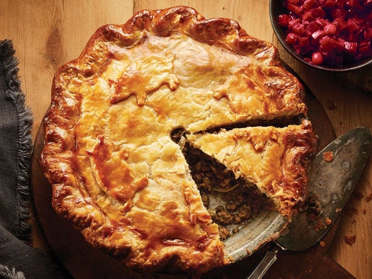 classic holiday tourtiere with a slice cut out
