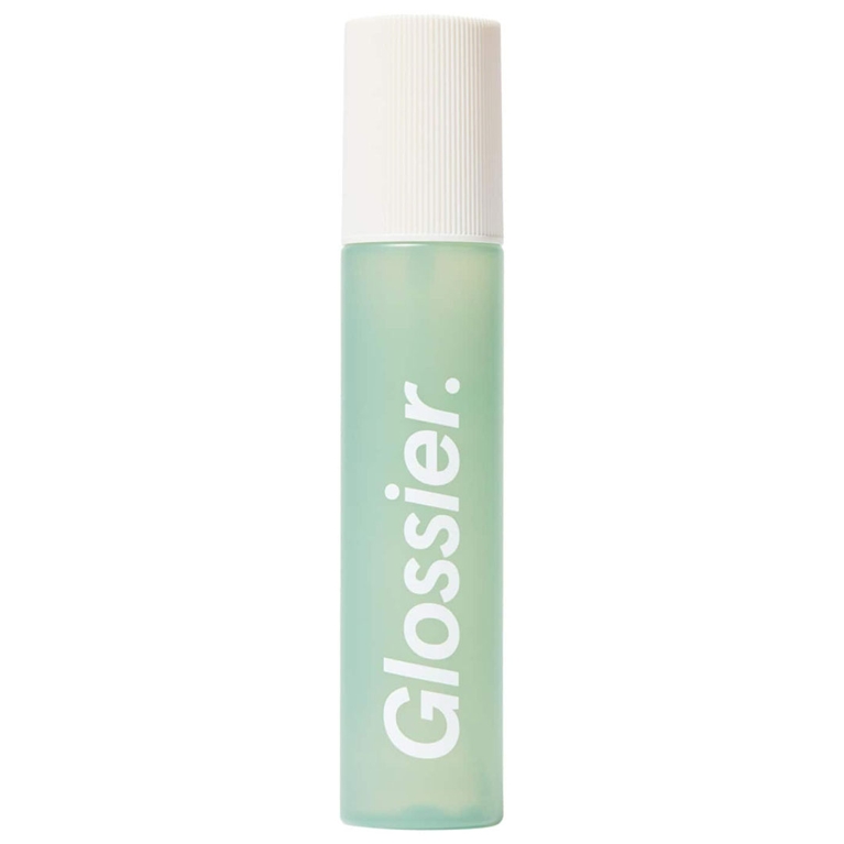 A bottle of Glossier Body Mist in Sandstone for an article about the best body mists to shop for summer.