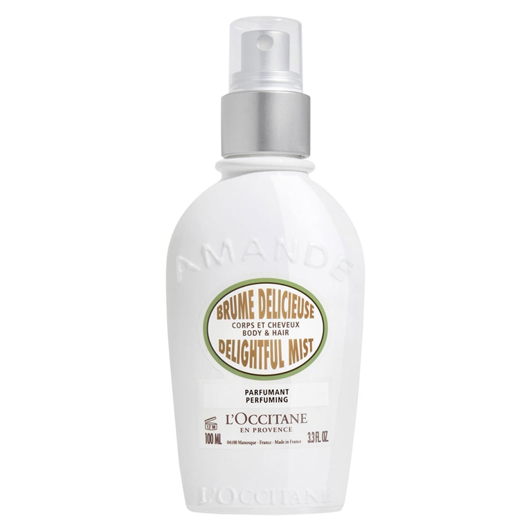 A bottle of L'Occitane Amande Hair and Body Mist for an article about the best body mists to shop for summer.