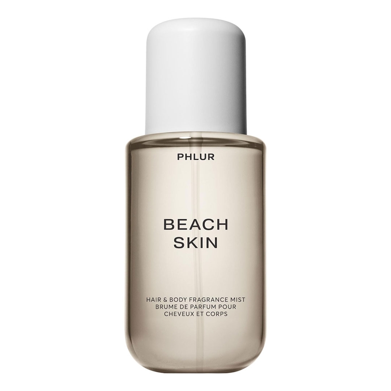 A bottle of Phlur Body Mist in Beach Skin for an article about the best body mists to shop for summer.