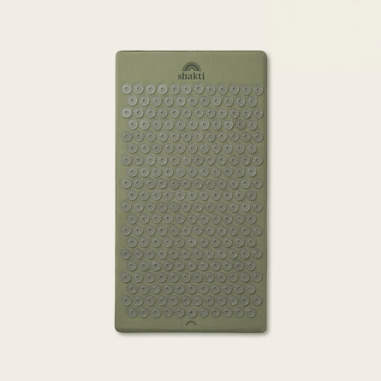 A sage green acupressure mat.