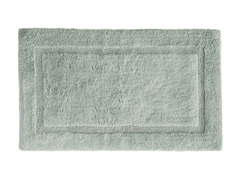 A sage green terry cloth bath mat by LL Bean.