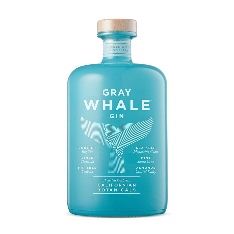 A turquoise bottle of Gray Whale Gin with an illustration of a whale's tale emerging from the water and the words "Juniper, big Sur"; "limes; Temecula"; "Fir tree, Sonoma"; "sea kelp; Mendocino coast"; "mint; Santa Cruz"; "almonds, Central Valley" and also "perfected with six Californian botanicals" for a post on the best bottles to gift