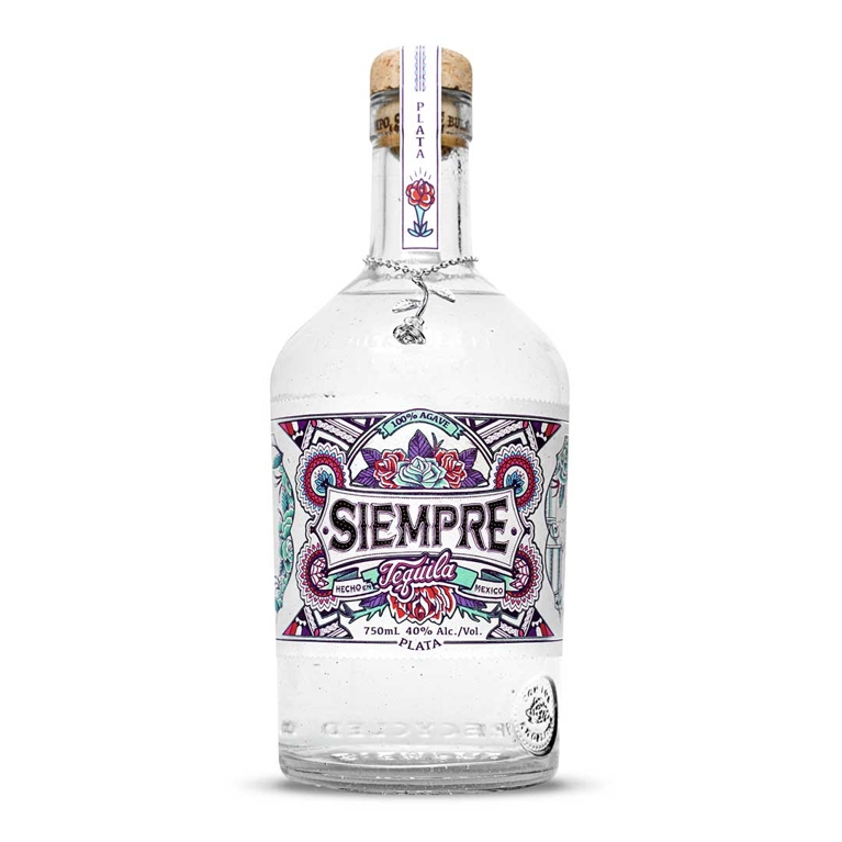 A bottle of Siempre Tequila plata with a colourful label with turquoise and red roses with purple leaves that reads "echo en Mexico" and "100% agave" for a post on the best alcoholic gift bottles to give to hostesses and friends