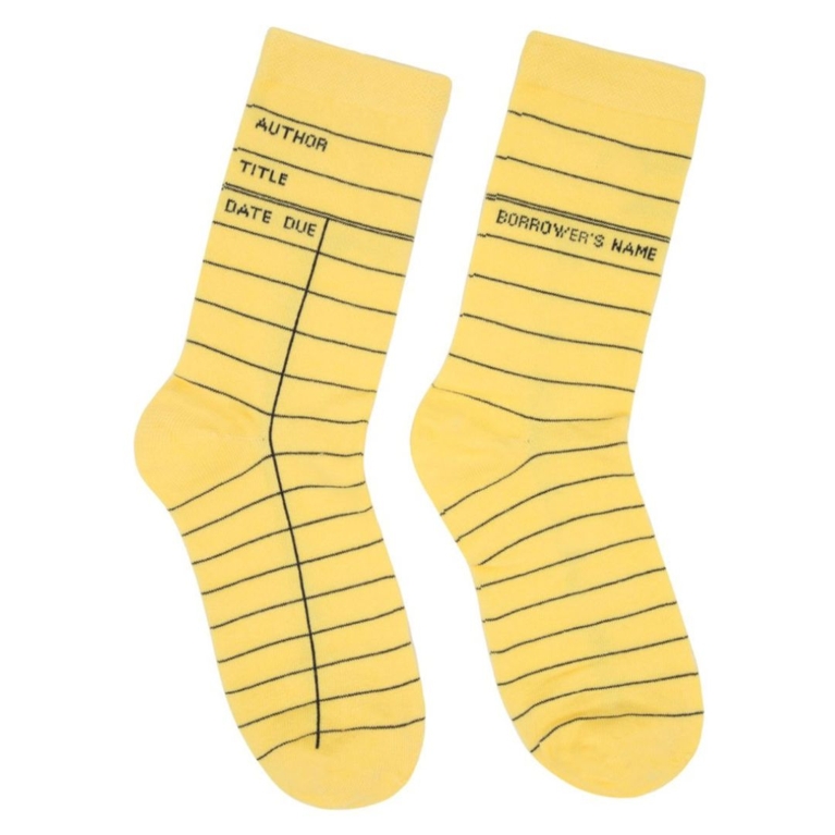 A pair of library card socks in yellow, for a post about the best gifts for book lovers.