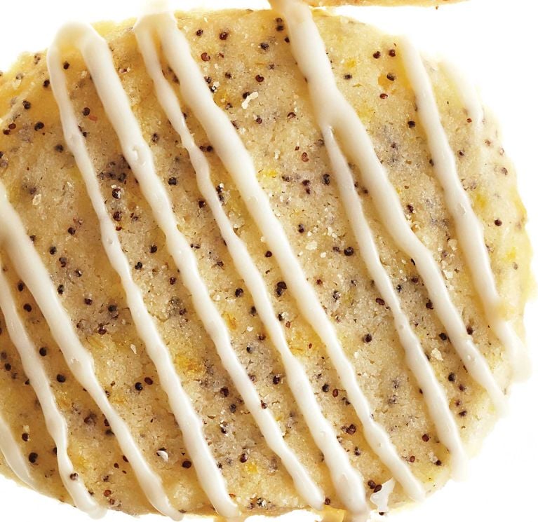 Lemon-poppyseed icebox shortbread cookie: Cookies with poppy seeds and lemon zest topped with an icing sugar and lemon glaze for a post on an easy Lemon-poppyseed icebox shortbread cookie recipe