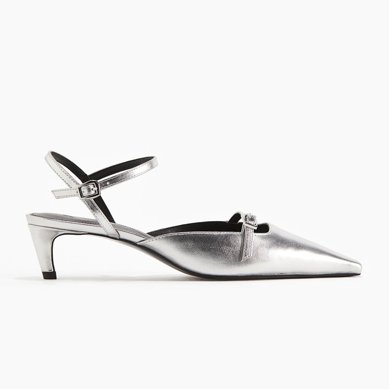 A pair of silver H&M kitten heels for an article about the silver shoe trend.