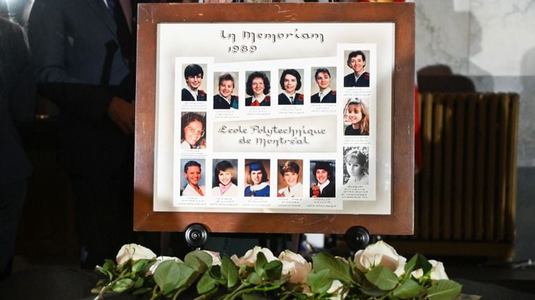 White roses are shown next to photographs of the fourteen women killed in the 1989 Polytechnique massacre during a vigil in their honour in Montreal, Wednesday, December 6, 2023