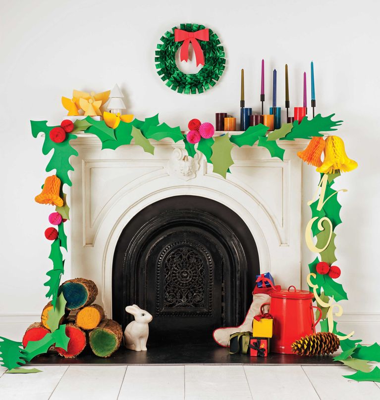 an accordion pleated paper wreath made from folded green construction paper with a red construction paper bow hanging above a festive mantle for a post on How To Make An Accordion Folded Paper Wreath