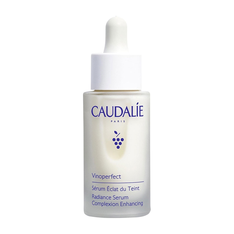 A bottle of Caudalie Vinoperfect Radiance Serum on a white background for an article about the best products for hyperpigmentation.